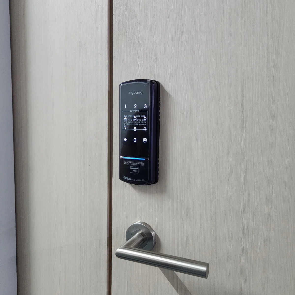 Zigbang 1321 Digital Lock installed above a silver lever handle on a light wooden door